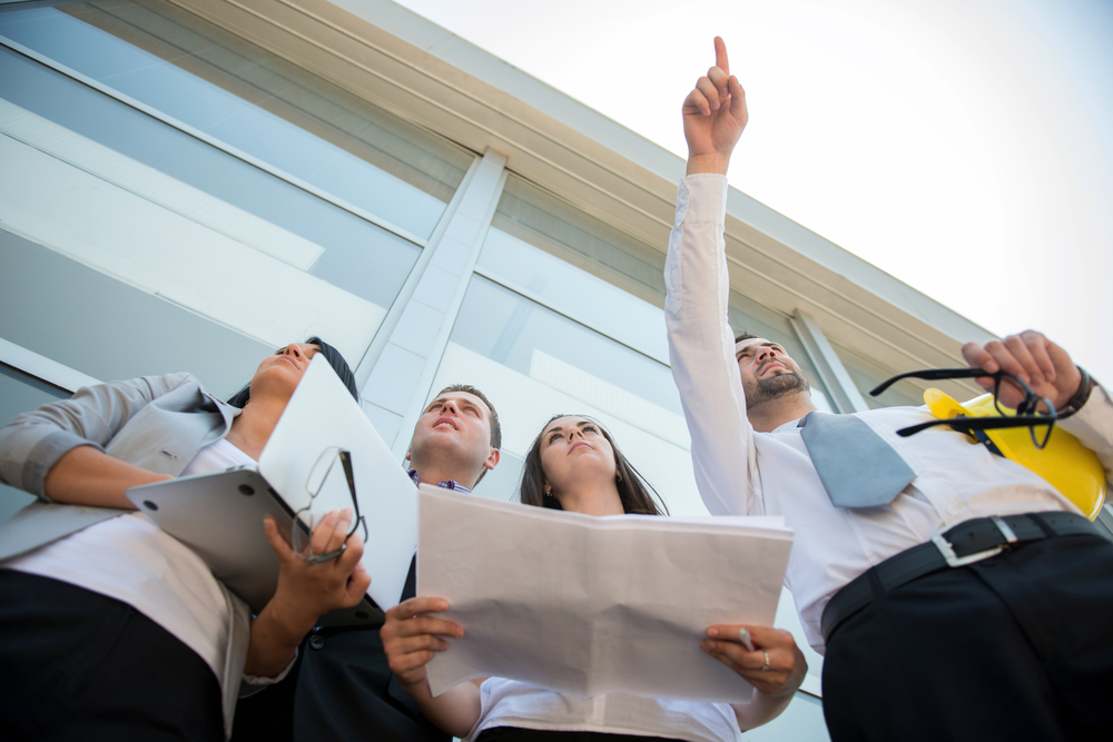 Team of engineers on construction site discussing Team of engineers on construction site discussing